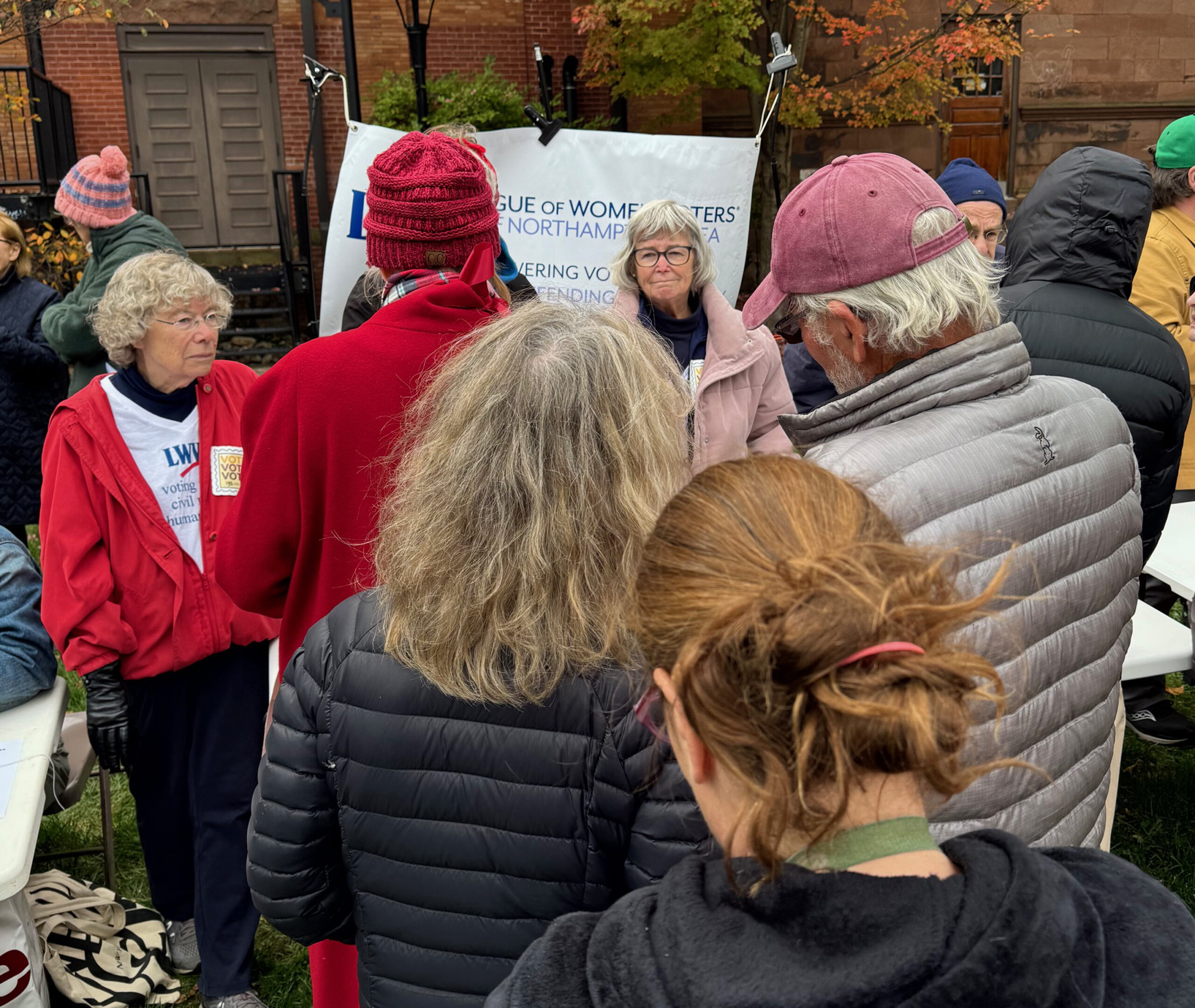Our voter education table at No Kings Vote Early on October 17 attracted a large crowd in spite of rain, cold, and wind!